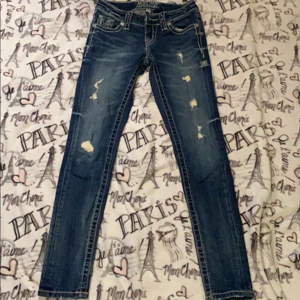 Dark pair of Miss Me Jeans w/ holes
